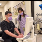 two dental staff members use a computer