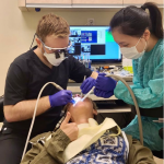 two dental staff members performing an exam