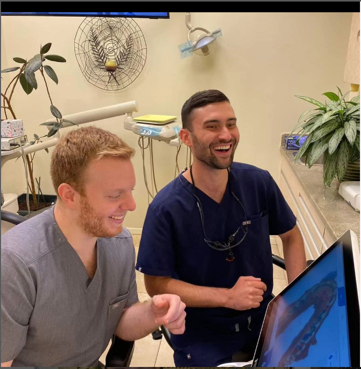 two dental staff members laughing