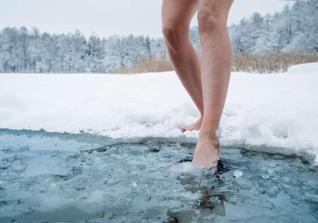 Woman stepping on cold water